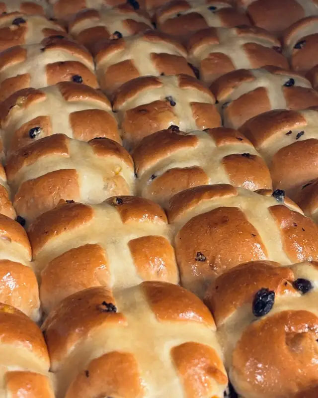 A tray of glazed hot cross buns